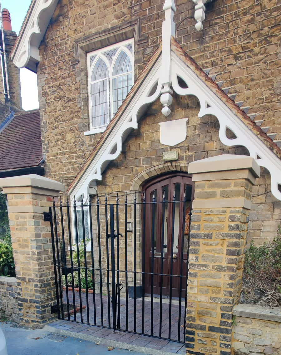 Front of cottage with new pillars and black gate