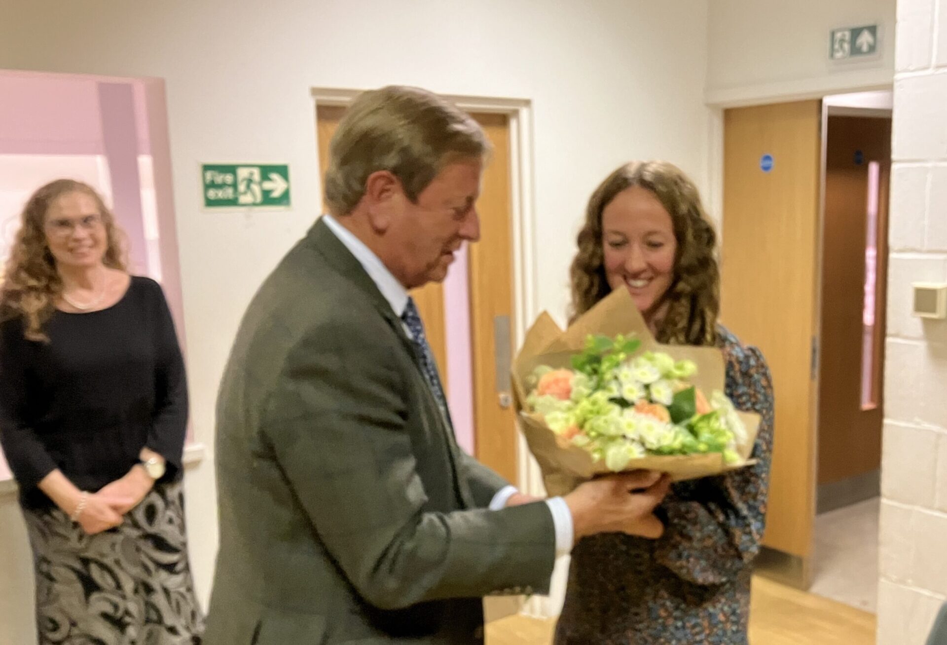 Jessica Greenhall, manager & clerk to the trustees, receiving a bouquet from the Lord Lieutenant in appreciation for her work for the charity.